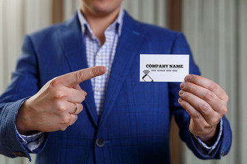 Businessman holding visit or business card.