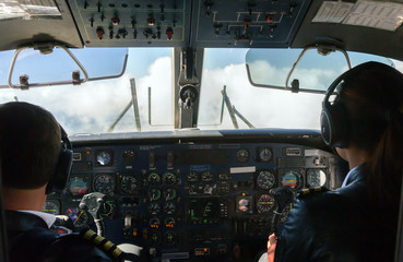 Fototapeta premium Pilots driving the Aircraft in the Sky rear View