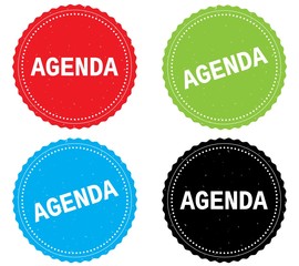 AGENDA text, on round wavy border stamp badge.
