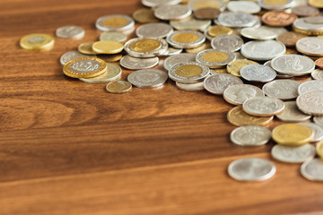 Different gold and silver collector's coins on the wooden table