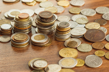 Different gold and silver collector's coins on the wooden table