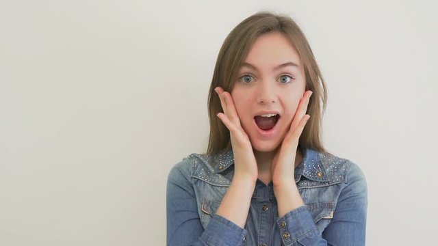 Smiling woman surprising with her mouth open