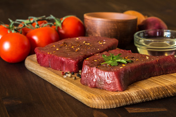 raw beef steak with ingredients for cooking