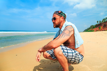 Bearded man on the beach.
