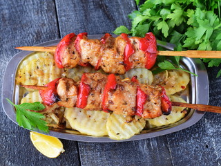Chicken fillet with sweet paprika grilled with fried potato on a metal plate on a wooden background. Healthy eating concept