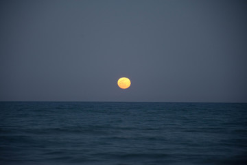 Sunset and the moon rising on the Mediterranean coast in southern Spain