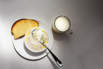 Healthy food - milk rice porridge with milk in a glass and toast (bread) Top view.