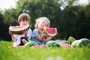 Fototapeta premium Funny kids eating watermelon outdoor.