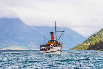 the stately old steamship SS Earnslaw lies moored up at the quayside. Lake Wakatipu stretches away...