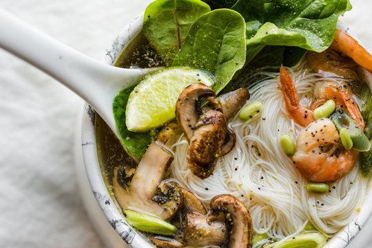  Bowl of Asian Noodle Soup with white ladle