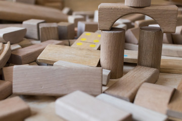 Wooden blocks for children focused on the colored one. Blocks for kids with bends and dotted parts