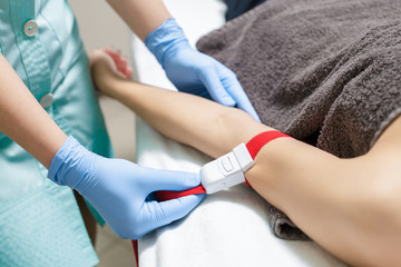 nurse taking blood sample from patient's arm. Preparation of blood to procedure Plasmolifting.