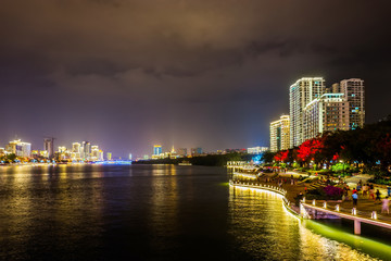 Panoramic view of illuminated Lichun river in the night. Sanya city on Hainan Island of China