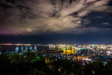 Obraz premium Night view of an artificial Phoenix island and Sanya city illuminated with city lights. View from Luhuitou Park on Hainan Island of China.