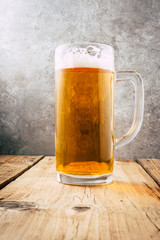 Glass of beer on wooden table. wallpaper with copy space