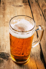 Glass of beer on wooden table. wallpaper with copy space