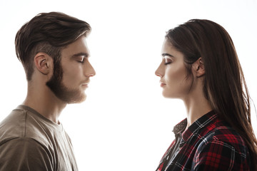 Side view. Man and woman facing each other, eyes closed. 