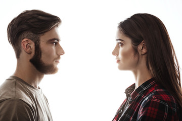 Side view. Man and woman facing each other, eyes open.