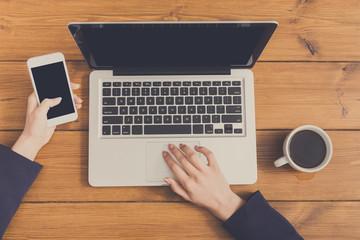 Woman using laptop in coffee shop, close-up