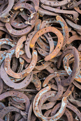 Large pile of rusty used Horseshoes
