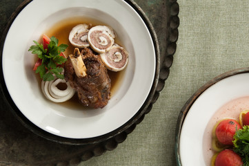 a meat dish with a bone on an old antique tray