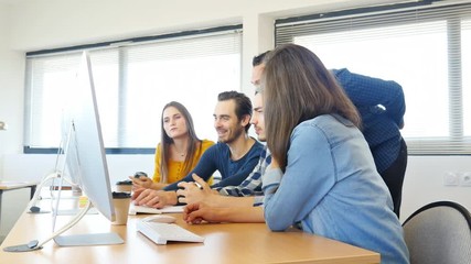 group of five young people student with their teacher in computer school classroom learning programming with desktop computer in a row - Powered by Adobe