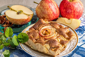 Apple pie on porcelian plate with mint and apples