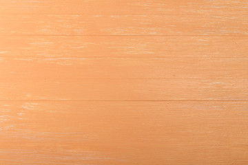 Orange wood background. Painted scraped wooden board. Bright texture or pattern.