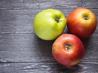 a variety of apples on wooden background