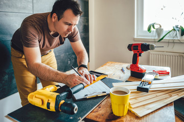 Man making draft plan using pencil