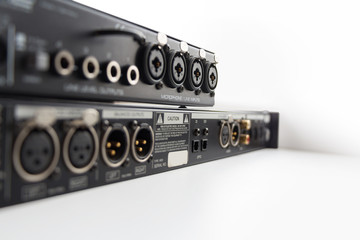 Professional sound equipment with input and output connectors. Selective focus