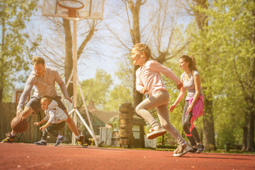 Fototapeta na wymiar Family playing basketball.