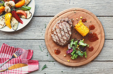 Grilled beef steak closeup on dark wooden table background