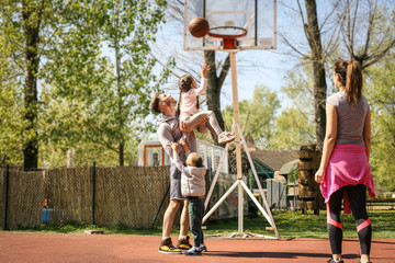 Family playing basketball.