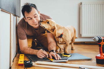 Man and his dog doing renovation work at home
