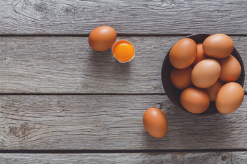 Brown and white organic eggs on wood background