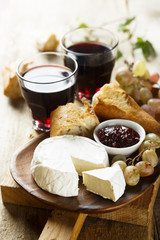 Cheese, fresh bread and marmalade with red wine
