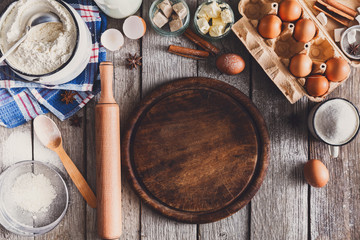 Baking ingredients on rustic wood background