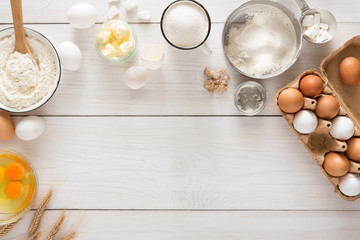 Baking ingredients on white rustic wood background, copy space