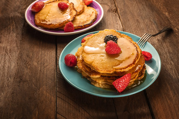Homemade pancakes with fresh fruit and honey