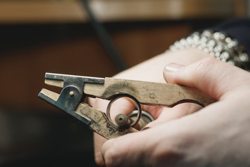 Close-up process of polishing ring made of white gold in a jewelry workshop.