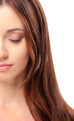 Fototapeta premium Natural as she is. Close up Portrait of beautiful young woman with close eyes while standing against white background. Half face crop.