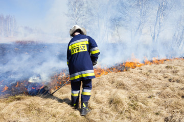 Firefighter fights grass fires. Polish firefighter. © Dagmara_K