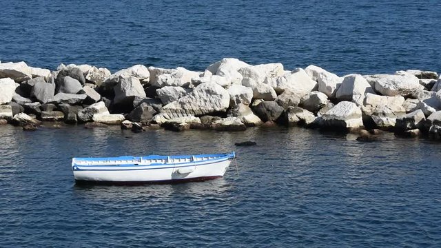 Wooden boat in the sea in Naples, Italy