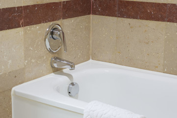 Close up white luxury bathtub with chrome faucet