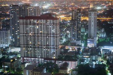 Condominium and skyscrapers at night in Bangkok Thailand