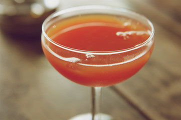 Glass of grapefruit juice on wood background vintage style
