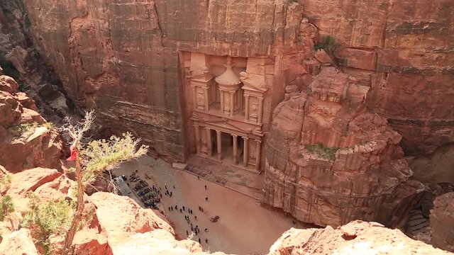 Top view of Al Khazneh or Treasury - Nabatean rock-cut temple of Hellenistic period of ancient Petra, originally known to Nabataeans as Raqmu - historical city in Hashemite Kingdom of Jordan