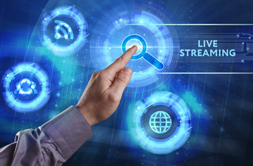Business, Technology, Internet and network concept. Young businessman working on a virtual screen of the future and sees the inscription: Live streaming