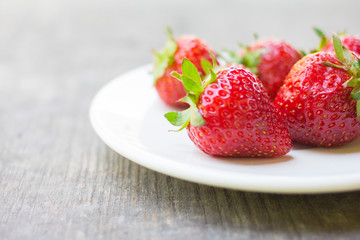 strawberry in a dish placed on the wood
